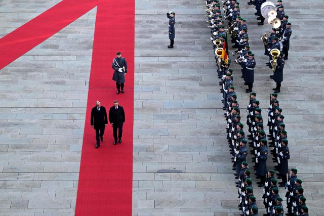 Germany's Chancellor Friedrich Merz (front, L) and Estonia's Prime Minister Kristen Michal (front, R) review a military honor guard during an official welcome ceremony in front of the Chancellery in Berlin, Germany, on November 27, 2025. (Photo by John MACDOUGALL / POOL / AFP)