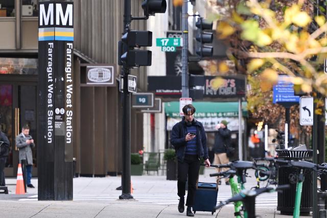 A man walks near the scene of a shooting in Washington, DC on November 27, 2025. Two National Guard troops were shot November 26 in a "targeted shooting," near the White House by an Afghan migrant who worked with the US military in Afghanistan. The United States is treating the shooting of two National Guards near the White House as a terrorism investigation, FBI director Kash Patel said Thursday. (Photo by MANDEL NGAN / AFP)