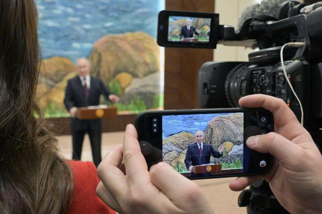 In this pool photograph distributed by the Russian state agency Sputnik, Russia's President Vladimir Putin meets with the Russian media in Bishkek on November 27, 2025. (Photo by Alexey NIKOLSKY / POOL / AFP)