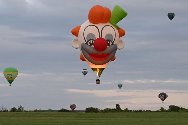 (FILES) Hot-air balloons fly over the Chambley-Bussieres air base in north-eastern France, during the first 'Enenvol' hot air balloon festival in Hageville, on July 28, 2025. It wanted to present the spectacle of hundreds of balloons in the sky, despite the cessation in 2023 of the Grand Est Mondial Air Ballons (GEMAB) in Chambley-Bussieres (Meurthe-et-Moselle): the EnEnvol festival confirmed to AFP on November 27, 2025 that it would not return in 2026, after only one edition. (Photo by Jean-Christophe VERHAEGEN / AFP)
