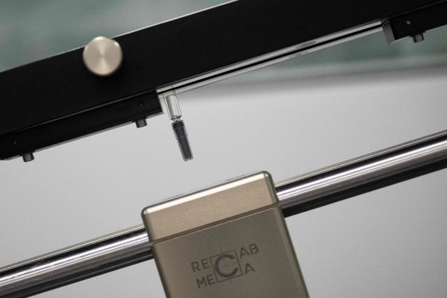 This photograph shows medication syringes on a production line during a press tour of the new biotechnology production facility at the industrial site of French pharmaceutical group Sanofi in Le Trait, southwestern France, on November 27, 2025. (Photo by LOU BENOIST / AFP)