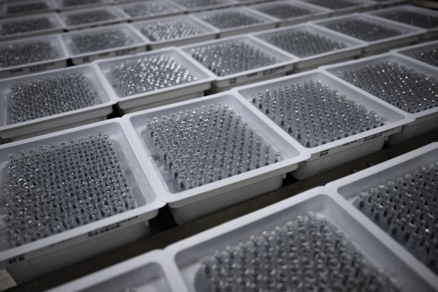 This photograph shows tubes for medication syringes on a production line during a press tour of the new biotechnology production facility at the industrial site of French pharmaceutical group Sanofi in Le Trait, southwestern France, on November 27, 2025. (Photo by LOU BENOIST / AFP)