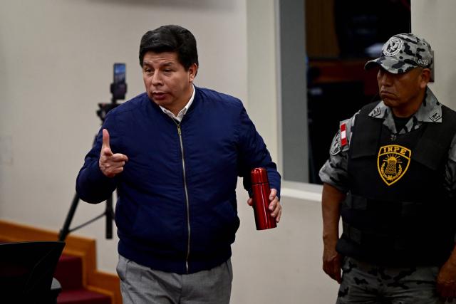 Peru's former President (2021–2022) Pedro Castillo gestures in the courtroom of the National Police Special Operations Directorate (DINOES) as the verdict is issued in his trial in Lima on November 27, 2025. A Peruvian court will issue its verdict on Thursday in the trial of former left-wing president Pedro Castillo, who was impeached and jailed all in the same day in 2022 following a power grab attempt. (Photo by ERNESTO BENAVIDES / AFP)