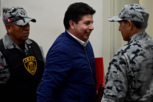 Peru's former President (2021–2022) Pedro Castillo leaves the courtroom of the National Police Special Operations Directorate (DINOES) during the verdict in his trial in Lima on November 27, 2025. A Peruvian court will issue its verdict on Thursday in the trial of former left-wing president Pedro Castillo, who was impeached and jailed all in the same day in 2022 following a power grab attempt. (Photo by ERNESTO BENAVIDES / AFP)