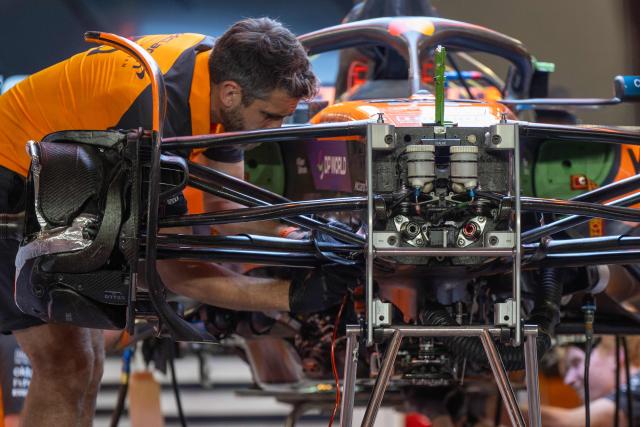 A mechanic works on the car of McLaren's British driver Lando Norris at the Lusail International Circuit ahead of the Formula One Qatar Grand Prix in Lusail on November 27, 2025. (Photo by Andrej ISAKOVIC / AFP)
