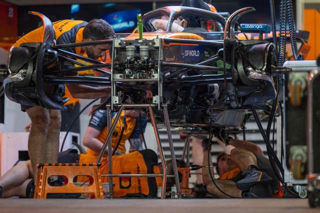 A mechanic works on the car of McLaren's British driver Lando Norris at the Lusail International Circuit ahead of the Formula One Qatar Grand Prix in Lusail on November 27, 2025. (Photo by Andrej ISAKOVIC / AFP)