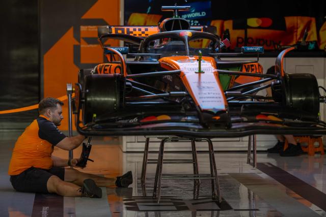 A mechanic works on the car of McLaren's Australian driver Oscar Piastri at the Lusail International Circuit ahead of the Formula One Qatar Grand Prix in Lusail on November 27, 2025. (Photo by Andrej ISAKOVIC / AFP)