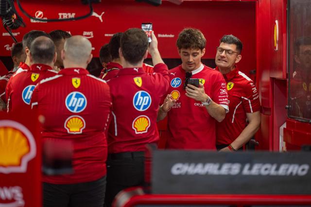 Ferrari's Monegasque driver Charles Leclerc is seen in the garage with his mechanics at the Lusail International Circuit ahead of the Formula One Qatar Grand Prix in Lusail on November 27, 2025. (Photo by Andrej ISAKOVIC / AFP)