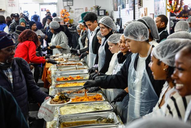 Volunteers serve meals at the National Action Network (NAN) Annual Thanksgiving Feeding event in Harlem, New York City, on Thanksgiving Day, November 27, 2025. (Photo by kena betancur / AFP)