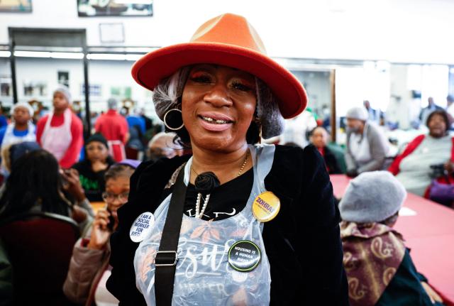 A volunteer pose for a picture at the National Action Network (NAN) Annual Thanksgiving Feeding event in Harlem, New York City, on Thanksgiving Day, November 27, 2025. (Photo by kena betancur / AFP)