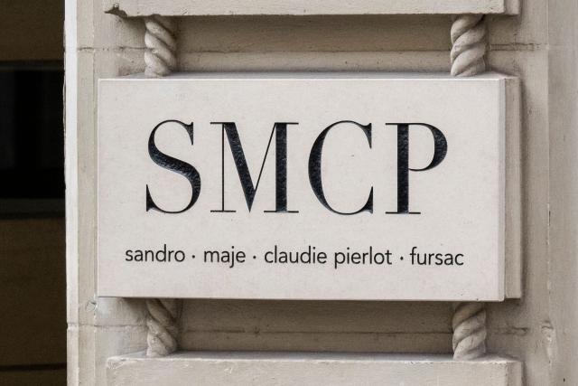 (FILES) This photograph shows the logo of SMCP Group (Sandro, Maje, Claudie Pierlot, Fursac) on a building facade in Paris on July 30, 2025. The textile group SMCP (Sandro, Maje, Claudie Pierlot and Fursac) announced on November 27, 2025 the sale of shares representing up to 51.2% of its capital, a process that will take "several months" and could allow it "to stabilize its shareholder situation". (Photo by Martin LELIEVRE / AFP)