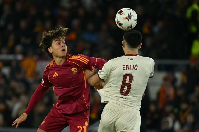 Midtjylland's Croatian defender #06 Martin Erlic fights for the ball with Roma's Argentine forward #21 Paulo Dybala during the UEFA Europa League 1st round day 5 football match between AS Roma and Midtjylland at the Olympic Stadium in Rome on November 27, 2025. (Photo by Filippo MONTEFORTE / AFP)