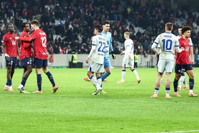 Lille's players (in red) greet Zagreb's players at the end of the UEFA Europa League football match between Lille (LOSC) and GNK Dinamo Zagreb at the Pierre-Mauroy Stadium in Villeneuve-d'Ascq, northern France, on November 27, 2025. (Photo by Sameer Al-DOUMY / AFP)
