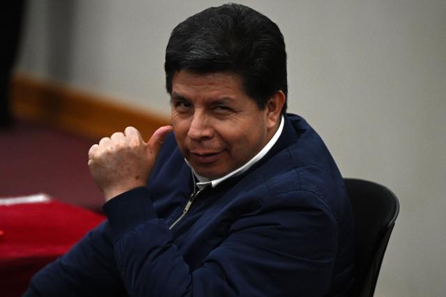 Peru's former President (2021–2022) Pedro Castillo gestures in the courtroom of the National Police Special Operations Directorate (DINOES) as the verdict is issued in his trial in Lima on November 27, 2025. A Peruvian court on Thursday sentenced former left-wing president Pedro Castillo to 11 years and five months in prison for trying to disband Congress and rule by decree in December 2022. (Photo by ERNESTO BENAVIDES / AFP)