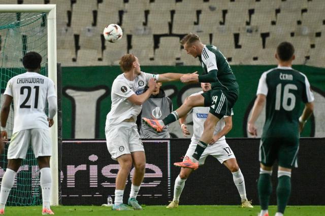 Panathinaikos' Polish forward #19 Karol Swiderski (R) heads the ball to score his team's first goal during theUEFA Europa League football match between Panathinaikos FC and SK Sturm Graz at the Apostolos Nikolaidis Stadium in Athens on November 27, 2025. (Photo by Aris MESSINIS / AFP)