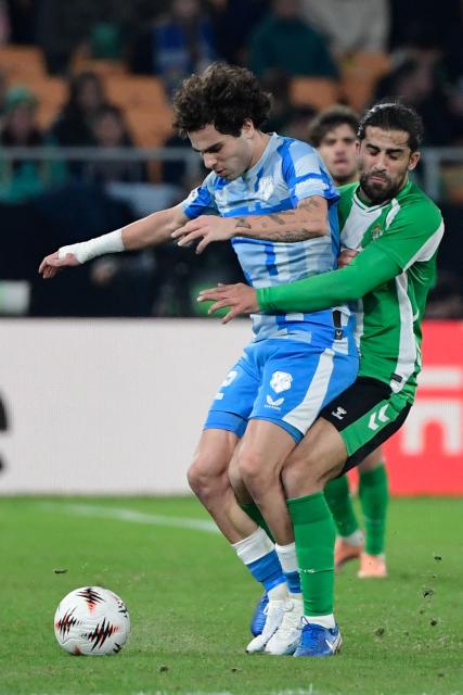 FC Utrecht's Spanish forward #22 Miguel Rodriguez (L) vies for the ball with Real Betis' Swiss defender #12 Ricardo Rodriguez during the UEFA Europa League first round football match between Real Betis and FC Utrecht at Benito Villamarin Stadium in Seville on November 27, 2025. (Photo by CRISTINA QUICLER / AFP)