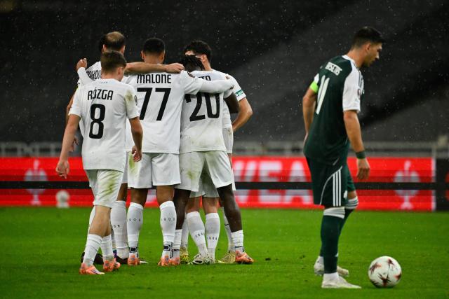 Sturm Graz's Georgian midfielder #10 Otar Kiteishvili (L, hidden) celebrates with teammates scoring his team's first goal during the  UEFA Europa League football match between Panathinaikos FC and SK Sturm Graz at the Apostolos Nikolaidis Stadium in Athens on November 27, 2025. (Photo by Aris MESSINIS / AFP)