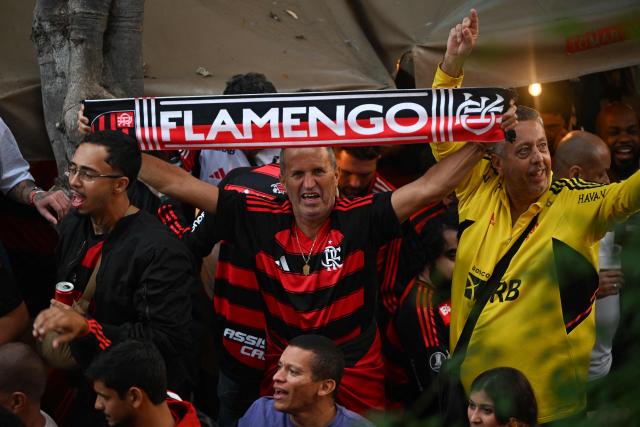 Flamengo fans cheer for their team in the streets during the "Samba Rubro-Negro" event in Lima on November 27, 2025. Flamengo will face Palmeiras in the Copa Libertadores final on November 29 in the Peruvian capital. (Photo by Luis ACOSTA / AFP)