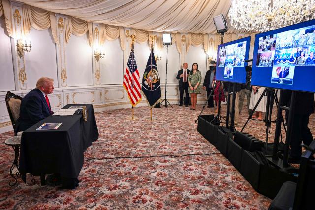 US President Donald Trump participates in a call with service members from his Mar-a-Lago residence in Palm Beach, Florida, on November 27, 2025, during the Thanksgiving holiday. US President Donald Trump said Thursday that Sarah Beckstrom, one of the two National Guard troops shot a day earlier near the White House, had died, while the other soldier was "fighting for his life." (Photo by Jim WATSON / AFP)
