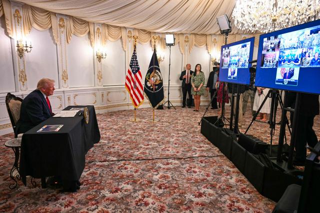 US President Donald Trump participates in a call with service members from his Mar-a-Lago residence in Palm Beach, Florida, on November 27, 2025, during the Thanksgiving holiday. US President Donald Trump said Thursday that Sarah Beckstrom, one of the two National Guard troops shot a day earlier near the White House, had died, while the other soldier was "fighting for his life." (Photo by Jim WATSON / AFP)