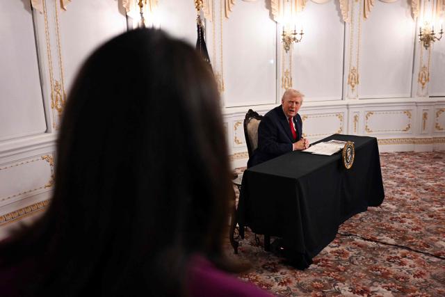 US President Donald Trump (R) answers a question to CBS News chief White House correspondent Nancy Cordes while participating in a video call with military service members from his Mar-a-Lago residence in Palm Beach, Florida, on November 27, 2025, during the Thanksgiving holiday. US President Donald Trump said Thursday that Sarah Beckstrom, one of the two National Guard troops shot a day earlier near the White House, had died, while the other soldier was "fighting for his life." (Photo by Jim WATSON / AFP)
