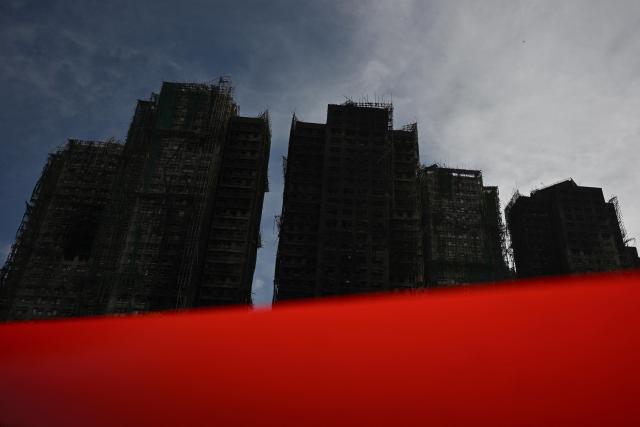 Damaged buildings are seen in the aftermath of a major fire that swept through several apartment blocks at the Wang Fuk Court residential estate in Hong Kong's Tai Po district on November 28, 2025. Hong Kong authorities said on November 28 the death toll from the city's worst fire in decades had risen to at least 94, with the blaze almost entirely extinguished and rescuers scouring torched high-rise buildings for scores of people still listed as missing. (Photo by Philip FONG / AFP)