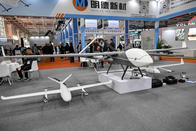 UAVs are seen at a booth during the Aero Asia 2025 in Zhuhai, in southern China's Guangdong province on November 28, 2025. Aero Asia 2025 is an international aviation and aerospace exhibition that runs between November 27 and 30. (Photo by Hector RETAMAL / AFP)