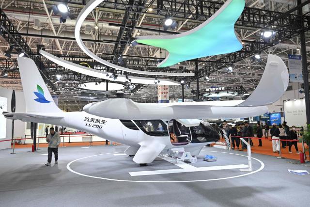 The LE200 eVTOL aircraft is seen at the Range Aviation booth during the Aero Asia 2025 in Zhuhai, in southern China's Guangdong province on November 28, 2025. Aero Asia 2025 is an international aviation and aerospace exhibition that runs between November 27 and 30. (Photo by Hector RETAMAL / AFP)
