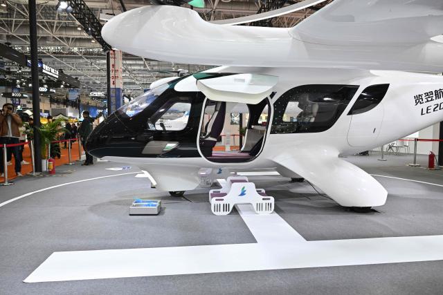 The LE200 eVTOL aircraft is seen at the Range Aviation booth during the Aero Asia 2025 in Zhuhai, in southern China's Guangdong province on November 28, 2025. Aero Asia 2025 is an international aviation and aerospace exhibition that runs between November 27 and 30. (Photo by Hector RETAMAL / AFP)