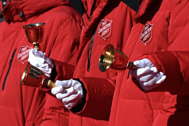 South Korean attendees ring their bells during a ceremony to launch a year-end fundraising campaign of the Salvation Army at Gwanghwamun square in Seoul on November 28, 2025. (Photo by Jung Yeon-je / AFP)