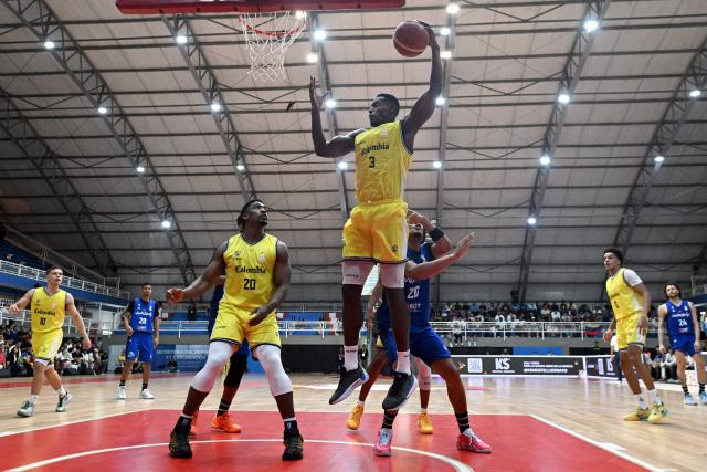 Colombia's Juan Tello shoots the ball during the FIBA Basketball World Cup 2027 Americas qualifiers Group C match between Colombia and Venezuela at the Coliseo Evangelista Mora in Cali, Colombia, on November 27, 2025. (Photo by Joaquín SARMIENTO / AFP)