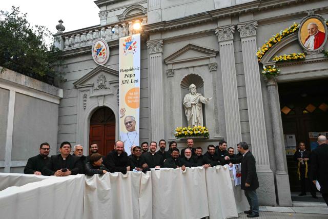 Clergymen wait for Pope Leo XIV outside the Cathedral of the Holy Spirit (St Esprit cathedral) before a meeting with bishops, priests, deacons, consecrated men and women, and pastoral workers, in Istanbul on November 28, 2025. (Photo by Andreas SOLARO / AFP)