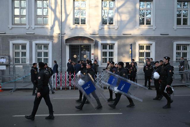 Policemen walk in the street near the Cathedral of the Holy Spirit (St Esprit cathedral) before the arrival of Pope Leo XIV for a meeting with bishops, priests, deacons, consecrated men and women, and pastoral workers, in Istanbul on November 28, 2025. (Photo by YASIN AKGUL / AFP)