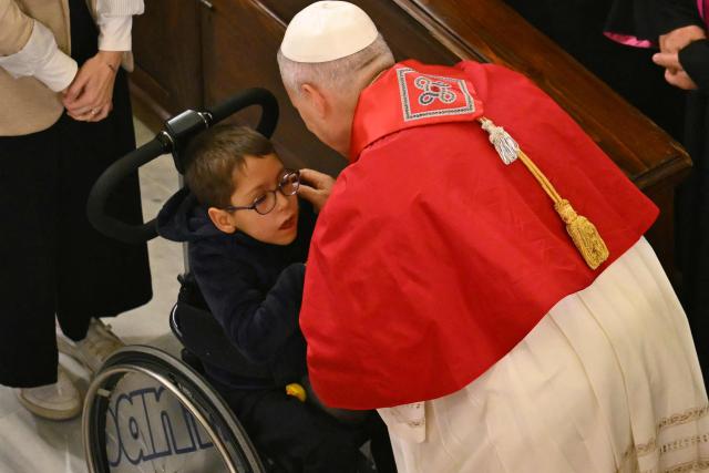 Pope Leo XIV greets a child on a wheelchair as he attends a meeting with bishops, priests, deacons, consecrated men and women, and pastoral workers at the Cathedral of the Holy Spirit (St Esprit cathedral) for, in Istanbul on November 28, 2025. (Photo by Andreas SOLARO / AFP)