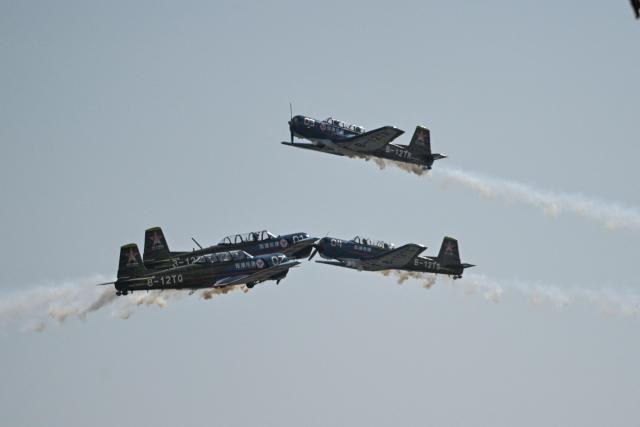 The Chinese Red Star Aerobatic Team performs during the Aero Asia 2025 in Zhuhai, in southern China's Guangdong province on November 28, 2025. Aero Asia 2025 is an international aviation and aerospace exhibition that runs between November 27 and 30. (Photo by Hector RETAMAL / AFP)