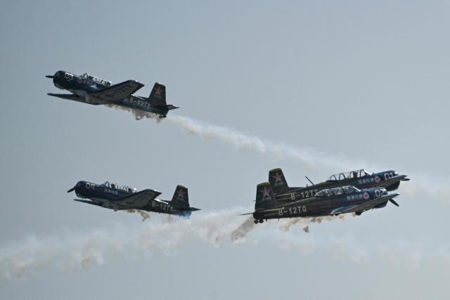 The Chinese Red Star Aerobatic Team performs during the Aero Asia 2025 in Zhuhai, in southern China's Guangdong province on November 28, 2025. Aero Asia 2025 is an international aviation and aerospace exhibition that runs between November 27 and 30. (Photo by Hector RETAMAL / AFP)