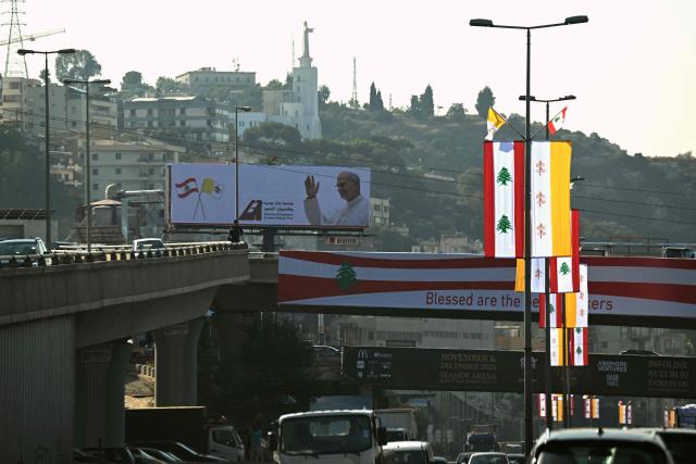 Vatican and Lebanese flags decorate the highway in Zouk Mosbeh, north of Beirut, on November 28, 2025 ahead of Pope Leo XIV's visit to Lebanon. In his first trip abroad since becoming head of the Catholic Church, US-born Pope Leo XIV is travelling to Turkey and Lebanon, arriving in Beirut on November 30. (Photo by Joseph EID / AFP)