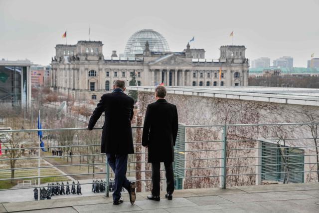 German Chancellor Friedrich Merz (L) and Slovenia's Prime Minister Robert Golob stand on a balcony of the Chancellery as in background can be seen the Reichstag building that houses the Bundestag (lower house of parliament) in Berlin, Germany, on November 28, 2025.  (Photo by Ebrahim Noroozi / POOL / AFP)