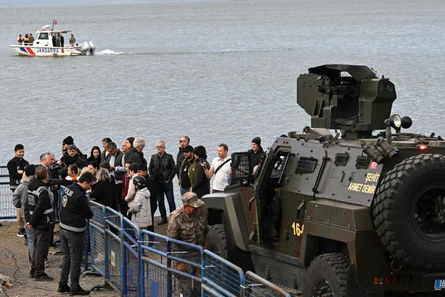 An armoured miltary vehicle and a gendarme boat secure the area next to police officers before the arrival of Pope Leo XIV to attend an ecumenical prayer service near the sunken Byzantine Basilica of Saint Neophytos by Lake Iznik, on November 28, 2025. Pope Leo XIV is on a four-day visit to Turkey. (Photo by OZAN KOSE / AFP)