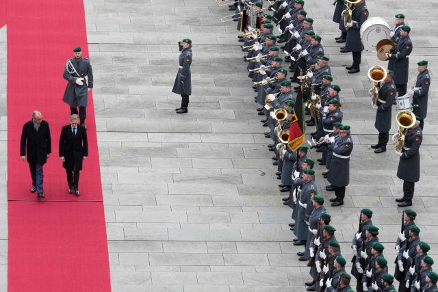 German Chancellor Friedrich Merz (L) and Slovenia’s Prime Minister Robert Golob inspect the honor guard during a welcoming ceremony at the Chancellery in Berlin on November 28, 2025. (Photo by Ebrahim Noroozi / POOL / AFP)