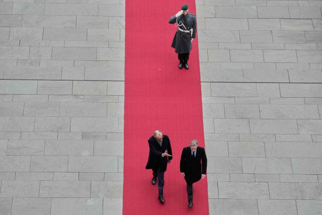 German Chancellor Friedrich Merz (L) and Slovenia’s Prime Minister Robert Golob inspect the honor guard during a welcoming ceremony at the Chancellery in Berlin on November 28, 2025. (Photo by Ebrahim Noroozi / POOL / AFP)