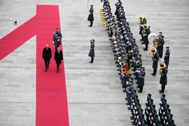 German Chancellor Friedrich Merz (L) and Slovenia’s Prime Minister Robert Golob inspect the honor guard during a welcoming ceremony at the Chancellery in Berlin on November 28, 2025. (Photo by Ebrahim Noroozi / POOL / AFP)