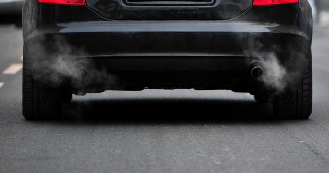 (FILES) Exhaust gases come out of the pipes of a car on December 1, 2010 in Berlin. Germany will urge the European Union to scrap its planned 2035 ban on the sale of combustion engine cars, Chancellor Friedrich Merz said on November 28, 2025, as Berlin battles to boost its embattled car industry. (Photo by JOHANNES EISELE / AFP)