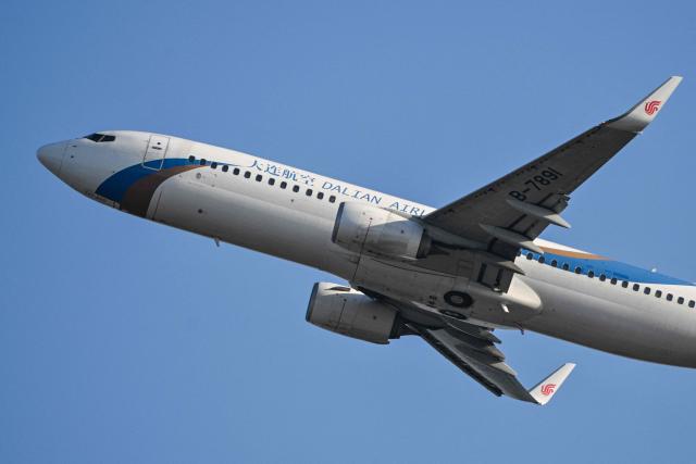 A Dalian Airlines Boeing 737-800 aircraft takes off from Zhuhai Jinwan Airport in Zhuhai, in southern China's Guangdong province on November 28, 2025. (Photo by Hector RETAMAL / AFP)