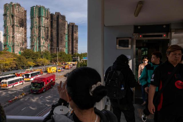 EDITORS NOTE: Graphic content / A general view shows the aftermath of a major fire that swept through several apartment blocks at the Wang Fuk Court residential estate in Hong Kong's Tai Po district on November 28, 2025. The death toll from Hong Kong's worst blaze in decades rose to 128 on November 28, with dozens still missing, as authorities said fire alarms in the residential estate buildings had been malfunctioning. (Photo by Dale DE LA REY / AFP)