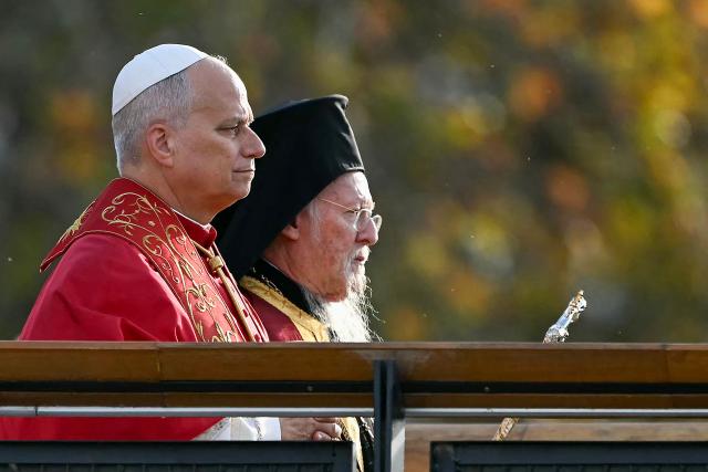 Pope Leo XIV and Patriarch Bartholomew I of Constantinople walk to attend an ecumenical prayer service near the sunken Byzantine Basilica of Saint Neophytos by Lake Iznik, on November 28, 2025. Pope Leo XIV is on a four-day visit to Turkey. (Photo by Ozan KOSE / AFP)