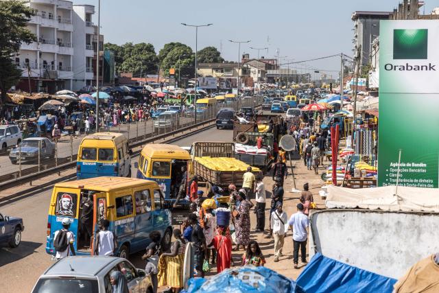 TOPSHOT - Public transport vehicles pick up passengers at a market in Bissau, on November 28, 2025. Life limped back to normal on Friday in the capital of volatile Guinea-Bissau after the west African nation's fifth coup that came on the heels of presidential and parliamentary polls.
The military appointed General Horta N'Tam, the army's chief of staff, as the country's new leader for a transition period of one year after Wednesday's putsch. The takeover came just one day before authorities had been due to announce the provisional results of the November 23 polls. There were vehicles and taxis along the main road from the port of the seaside capital Bissau to the presidential palace, as well as pedestrians (Photo by PATRICK MEINHARDT / AFP)