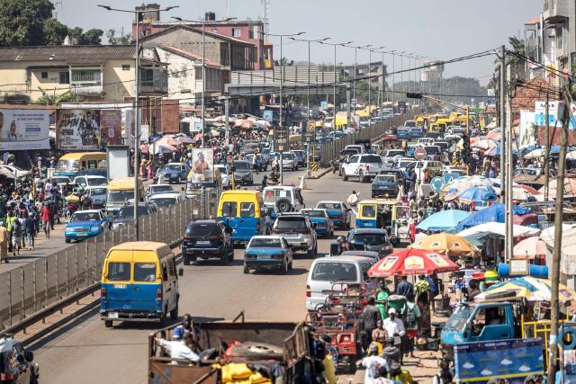 A general view of vehicles driving past a market in Bissau, on November 28, 2025. Life limped back to normal on Friday in the capital of volatile Guinea-Bissau after the west African nation's fifth coup that came on the heels of presidential and parliamentary polls.
The military appointed General Horta N'Tam, the army's chief of staff, as the country's new leader for a transition period of one year after Wednesday's putsch. The takeover came just one day before authorities had been due to announce the provisional results of the November 23 polls. There were vehicles and taxis along the main road from the port of the seaside capital Bissau to the presidential palace, as well as pedestrians (Photo by PATRICK MEINHARDT / AFP)