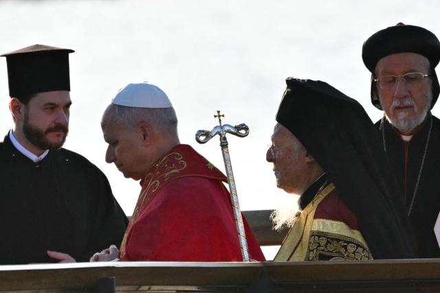 Pope Leo XIV and Patriarch Bartholomew I of Constantinople attend an ecumenical prayer service near the sunken Byzantine Basilica of Saint Neophytos by Lake Iznik, on November 28, 2025. (Photo by Andreas SOLARO / AFP)
