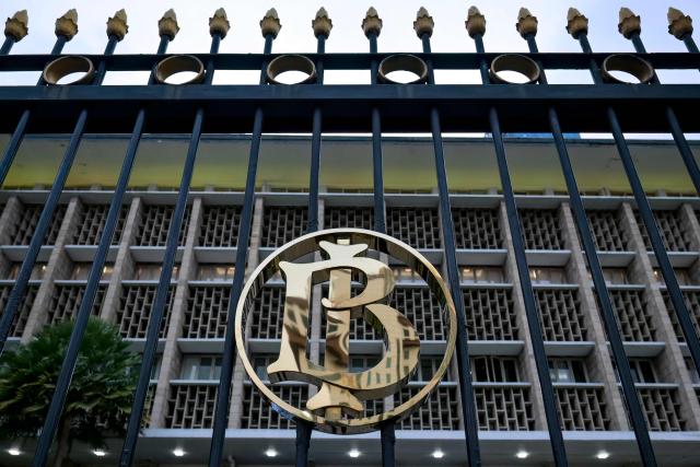 The logo of Bank Indonesia (Indonesia's Central Bank) is displayed on an iron fance at its main building in Jakarta, on November 28, 2025. (Photo by BAY ISMOYO / AFP)